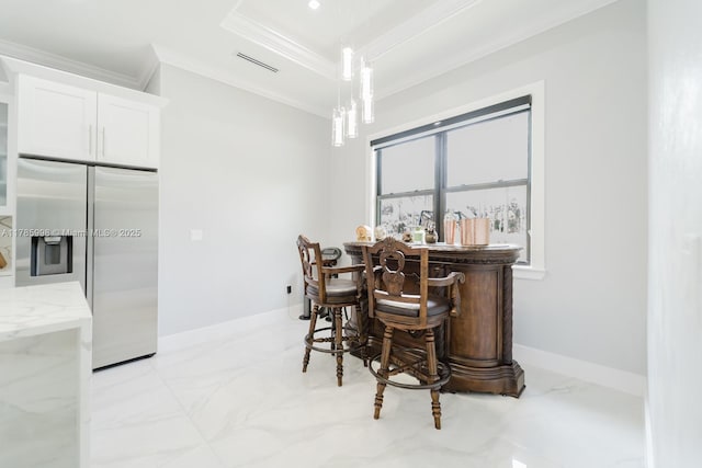 398 35th Ave NW, Naples, FL 34120 - dining area with a dry bar, visible vents, baseboards, marble finish floor, and crown molding