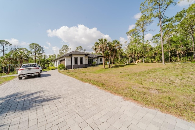 398 35th Ave NW, Naples, FL 34120 - single story home with an attached garage, a front lawn, stucco siding, and decorative driveway