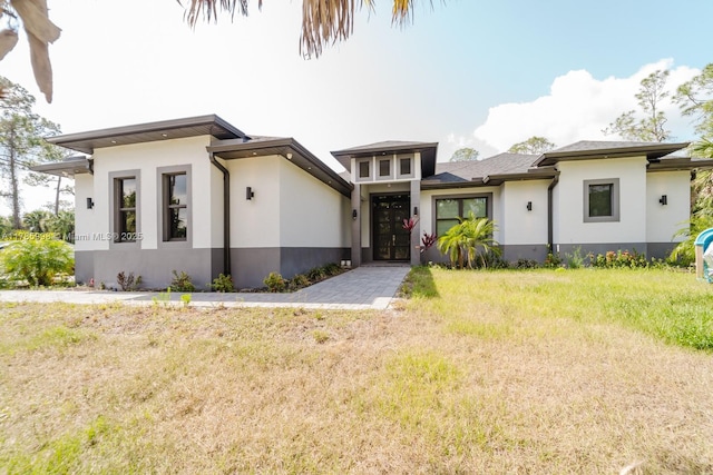 398 35th Ave NW, Naples, FL 34120 - prairie-style home with a front yard and stucco siding