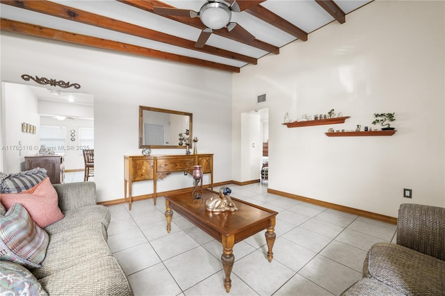 living room featuring visible vents, light tile patterned flooring, baseboards, lofted ceiling with beams, and ceiling fan