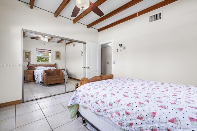 bedroom featuring visible vents, vaulted ceiling with beams, a ceiling fan, light tile patterned floors, and a closet