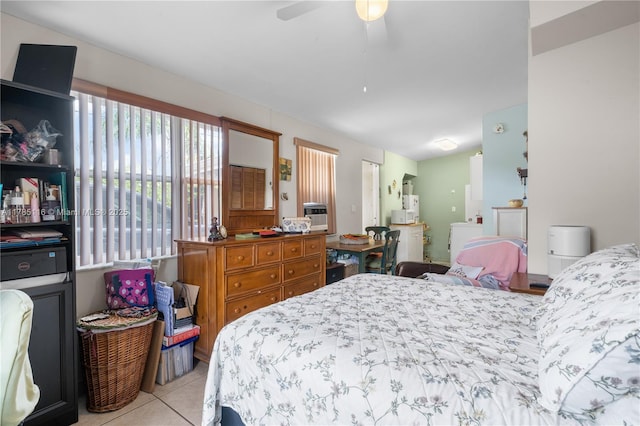 tiled bedroom with a ceiling fan and washer / clothes dryer