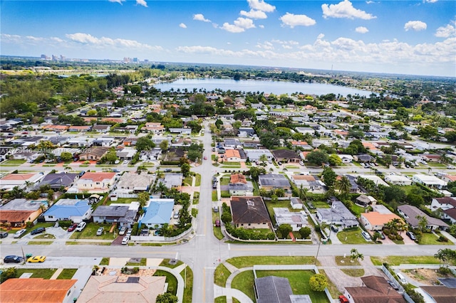 birds eye view of property with a water view and a residential view