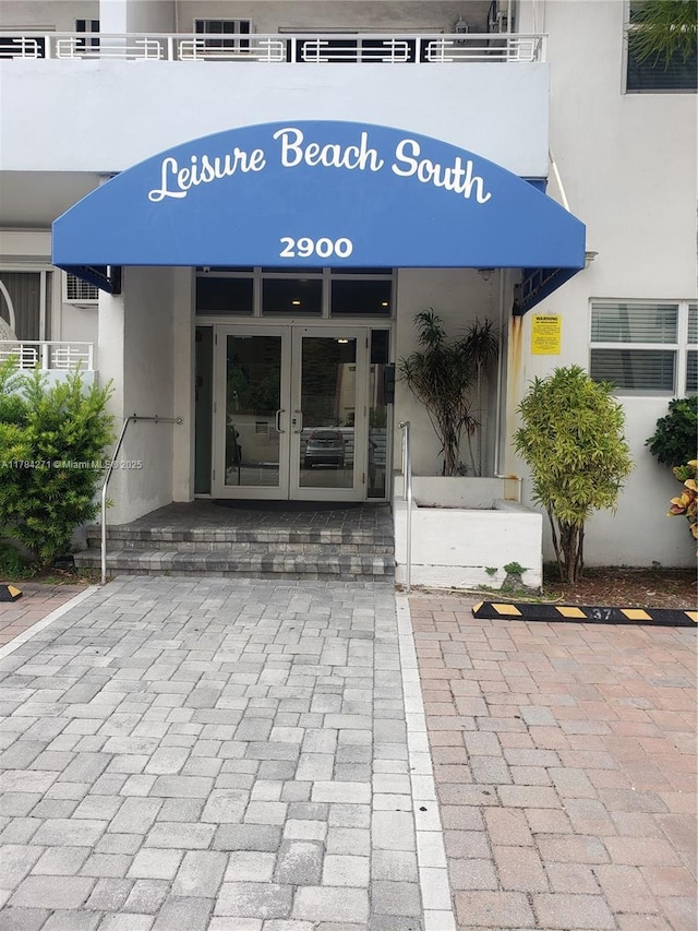 2900 Banyan St Unit 303, Fort Lauderdale, FL 33316 - doorway to property with french doors and stucco siding