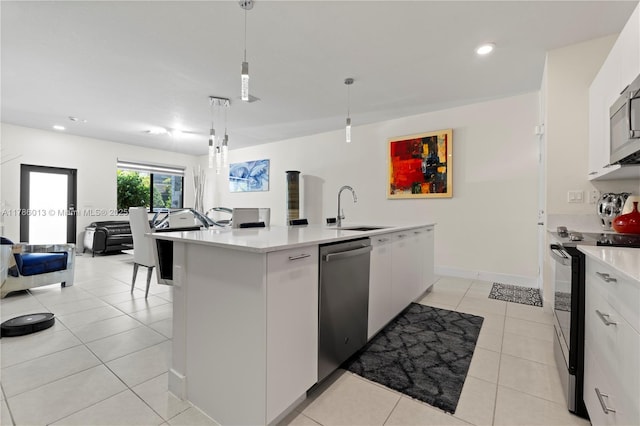 8292 NW 43rd St, Doral, FL 33166 - kitchen with electric range oven, stainless steel dishwasher, light countertops, white cabinets, and recessed lighting