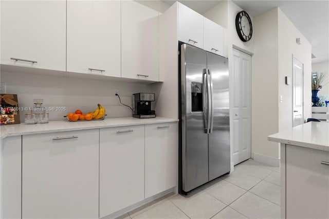 8292 NW 43rd St, Doral, FL 33166 - kitchen with stainless steel refrigerator with ice dispenser, light tile patterned flooring, white cabinets, and modern cabinets