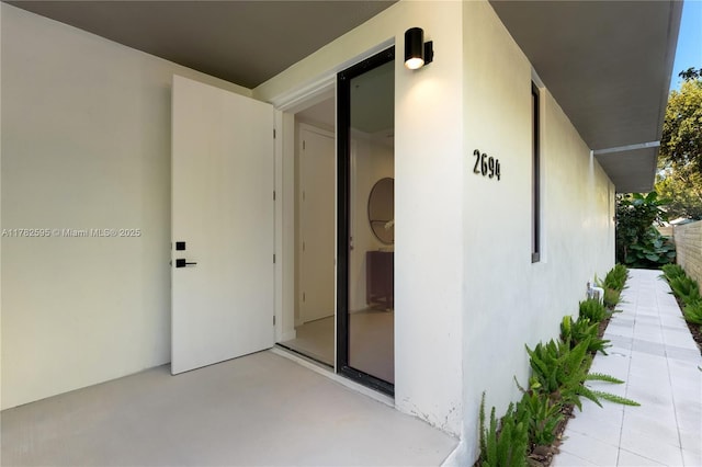 2501 SW 27th St Unit 6, Miami, FL 33133 - entrance to property with a patio area and stucco siding