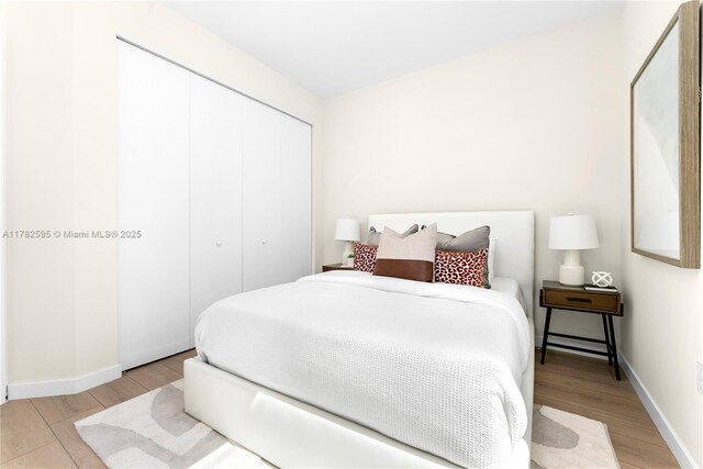 2501 SW 27th St Unit 6, Miami, FL 33133 - bedroom featuring light wood-type flooring, a closet, and baseboards