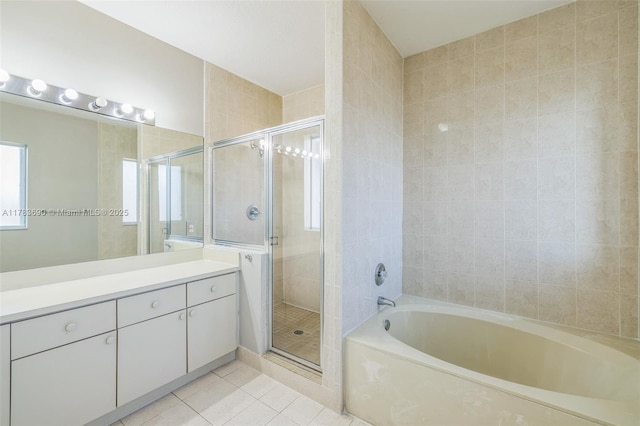 bathroom with a bath, a shower stall, tile patterned floors, and vanity