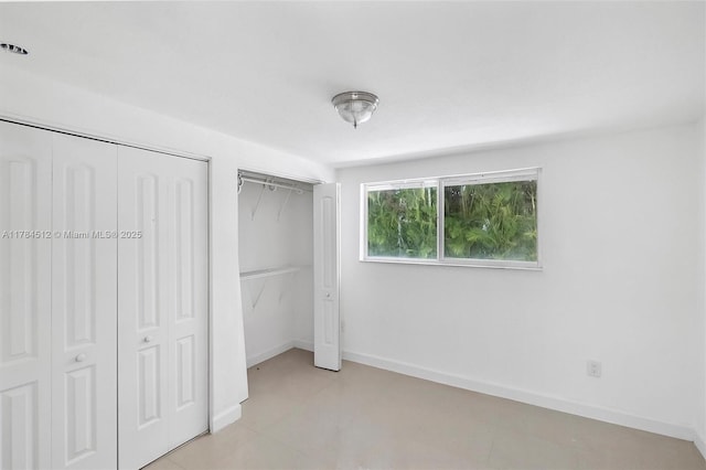 unfurnished bedroom featuring multiple closets and baseboards
