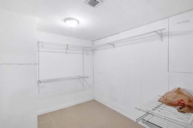 walk in closet featuring visible vents and light tile patterned floors