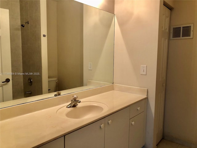 bathroom with walk in shower, visible vents, vanity, and toilet