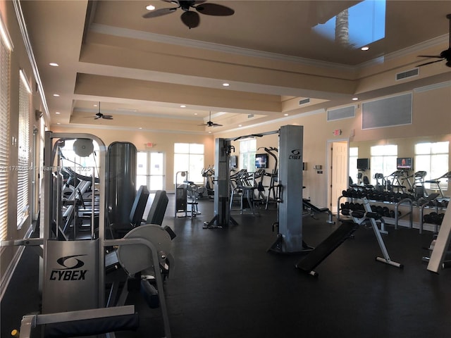 gym featuring a raised ceiling, visible vents, a ceiling fan, and ornamental molding