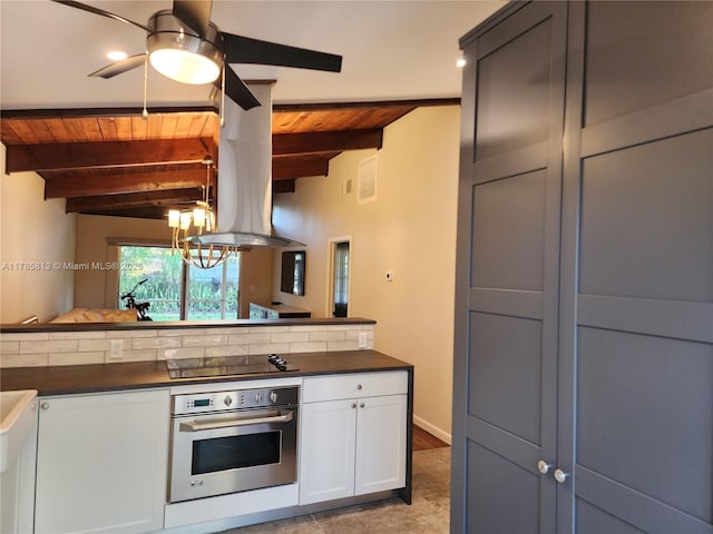 kitchen with stainless steel oven, wood ceiling, dark countertops, and black electric cooktop