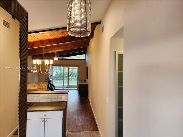 corridor with dark wood finished floors, an inviting chandelier, visible vents, wooden ceiling, and baseboards