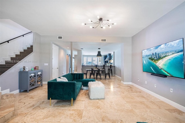 7765 SW 54th Ct Unit 7765, Miami, FL 33143 - living room featuring baseboards, visible vents, stairs, and a notable chandelier