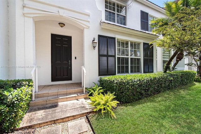 7765 SW 54th Ct Unit 7765, Miami, FL 33143 - view of exterior entry with a lawn and stucco siding