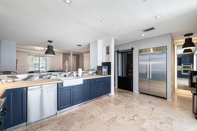 7765 SW 54th Ct Unit 7765, Miami, FL 33143 - kitchen with a sink, stainless steel appliances, light countertops, blue cabinetry, and visible vents
