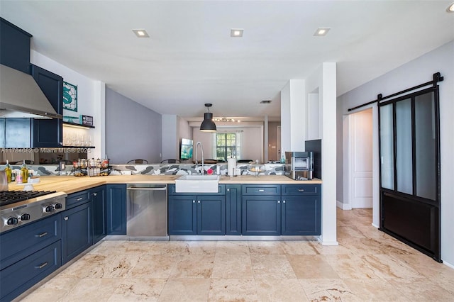 7765 SW 54th Ct Unit 7765, Miami, FL 33143 - kitchen featuring blue cabinets, wall chimney range hood, a peninsula, and a sink