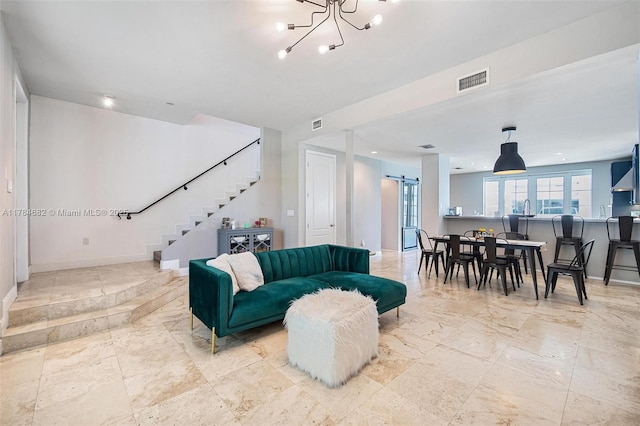 7765 SW 54th Ct Unit 7765, Miami, FL 33143 - living area with a barn door, visible vents, baseboards, a chandelier, and stairs