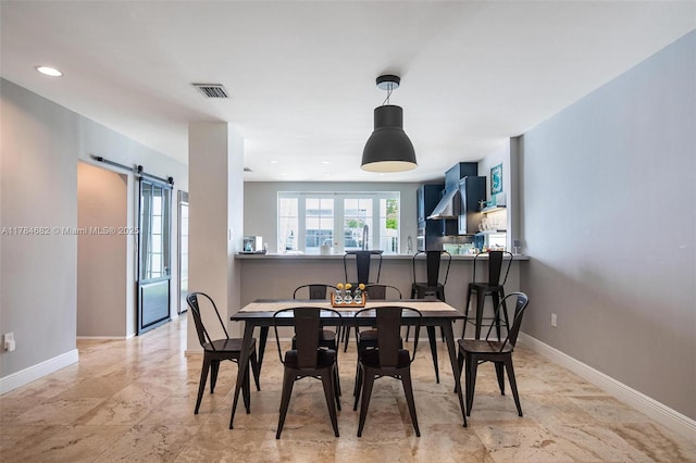 7765 SW 54th Ct Unit 7765, Miami, FL 33143 - dining area featuring a barn door, baseboards, and visible vents