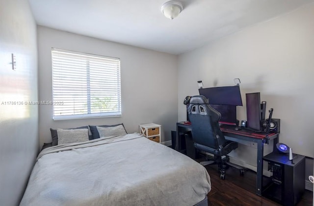 bedroom with dark wood finished floors
