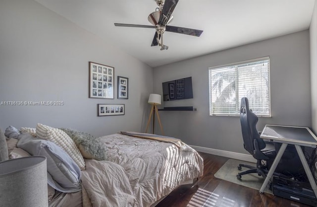 bedroom with ceiling fan, baseboards, and wood finished floors