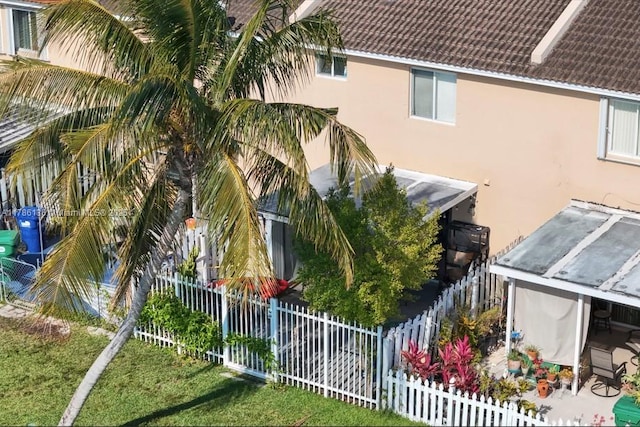 exterior space featuring stucco siding and a fenced backyard