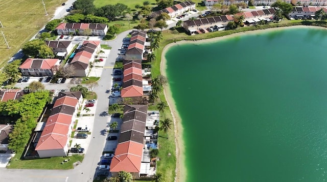 drone / aerial view with a water view and a residential view