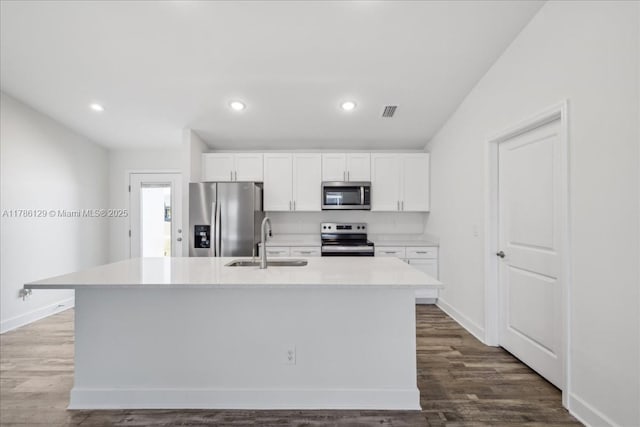 1909 NE 2nd Ave, Cape Coral, FL 33909 - kitchen featuring stainless steel appliances, a sink, an island with sink, white cabinetry, and baseboards