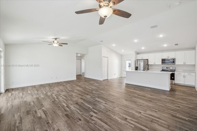 1909 NE 2nd Ave, Cape Coral, FL 33909 - unfurnished living room featuring ceiling fan, vaulted ceiling, dark wood-style flooring, recessed lighting, and a sink