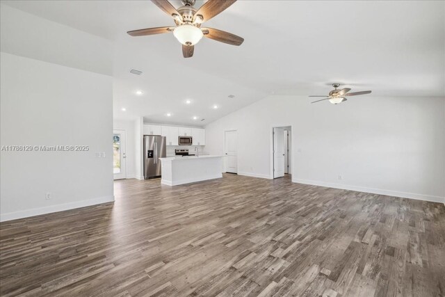 1909 NE 2nd Ave, Cape Coral, FL 33909 - unfurnished living room with ceiling fan, lofted ceiling, wood finished floors, recessed lighting, and baseboards
