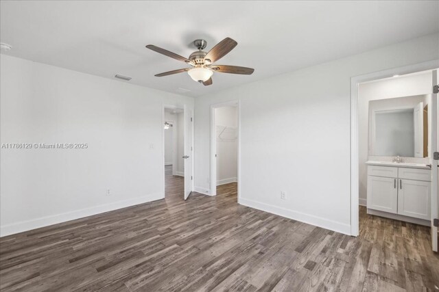 1909 NE 2nd Ave, Cape Coral, FL 33909 - unfurnished bedroom featuring a spacious closet, wood finished floors, baseboards, and a closet