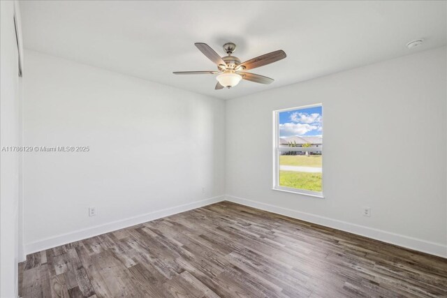 1909 NE 2nd Ave, Cape Coral, FL 33909 - unfurnished room featuring wood finished floors, baseboards, a ceiling fan, and a smoke detector