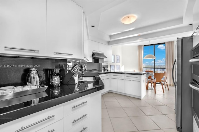 2000 Island Blvd Unit 1704, Aventura, FL 33160 - kitchen with a peninsula, dark countertops, white cabinets, and a sink