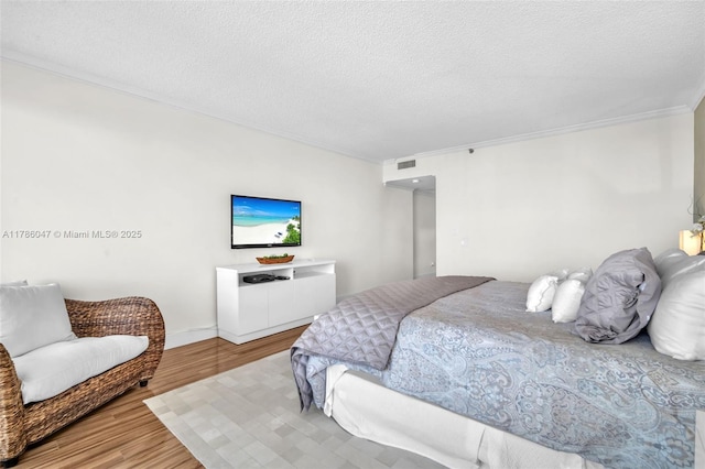 2000 Island Blvd Unit 1704, Aventura, FL 33160 - bedroom with visible vents, crown molding, a textured ceiling, and wood finished floors