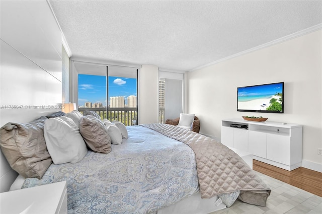 2000 Island Blvd Unit 1704, Aventura, FL 33160 - bedroom featuring a textured ceiling, wood finished floors, access to exterior, and ornamental molding