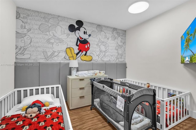 2000 Island Blvd Unit 1704, Aventura, FL 33160 - bedroom with a nursery area and wood finished floors