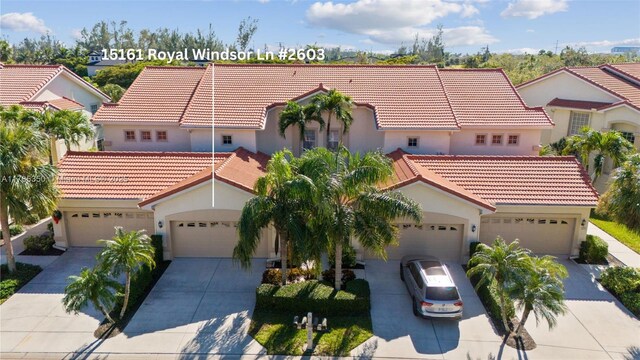 15161 Royal Windsor Ln Unit 2603, Fort Myers, FL 33919 - mediterranean / spanish-style house featuring a tiled roof, stucco siding, and concrete driveway