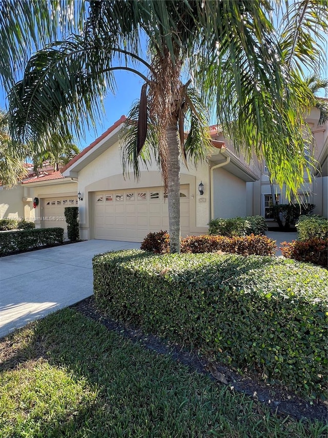 15161 Royal Windsor Ln Unit 2603, Fort Myers, FL 33919 - view of front facade with stucco siding, an attached garage, and concrete driveway