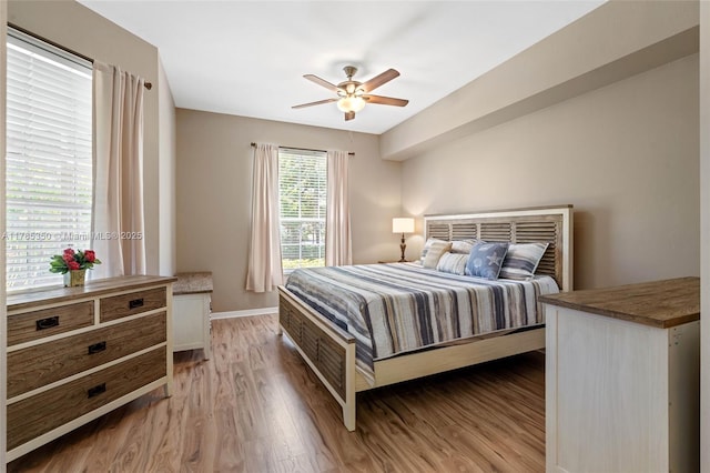 15161 Royal Windsor Ln Unit 2603, Fort Myers, FL 33919 - bedroom with light wood finished floors, baseboards, and ceiling fan