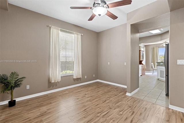 15161 Royal Windsor Ln Unit 2603, Fort Myers, FL 33919 - spare room featuring a ceiling fan, light wood finished floors, and baseboards