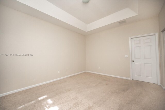 445 NE 21st Ave, Homestead, FL 33033 - spare room featuring light carpet and a raised ceiling