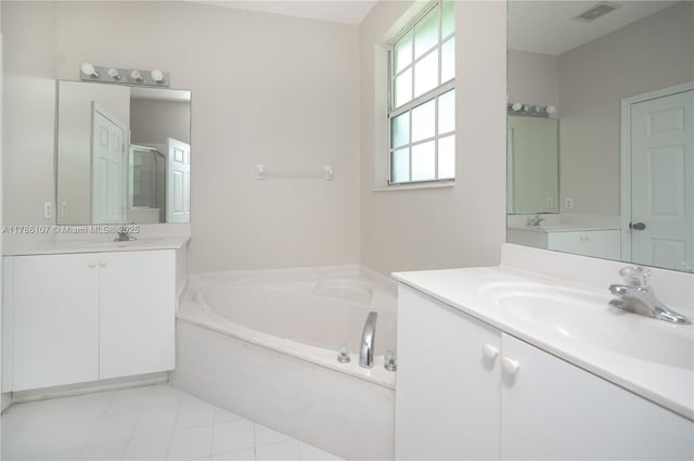 445 NE 21st Ave, Homestead, FL 33033 - bathroom featuring two vanities, a garden tub, tile patterned floors, and an enclosed shower