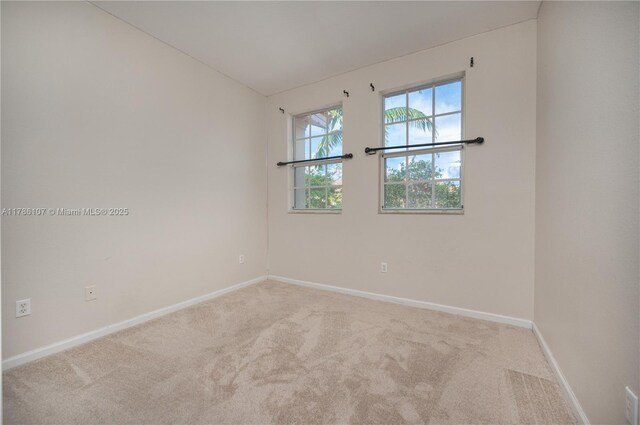 445 NE 21st Ave, Homestead, FL 33033 - carpeted empty room featuring baseboards and vaulted ceiling