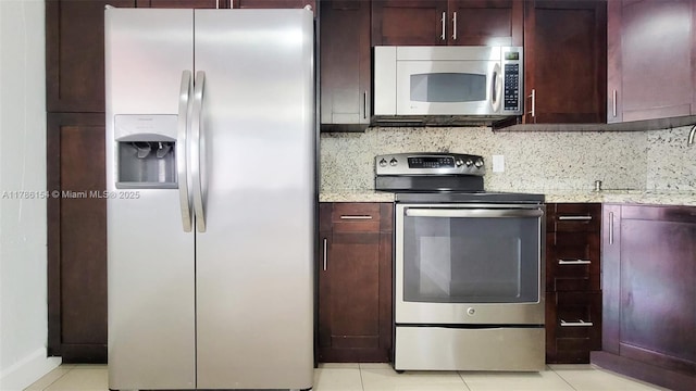 kitchen with backsplash, appliances with stainless steel finishes, and light stone countertops