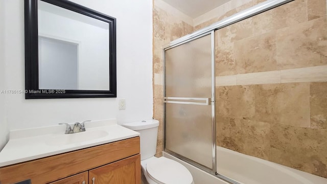 full bathroom with toilet, vanity, and shower / bath combination with glass door