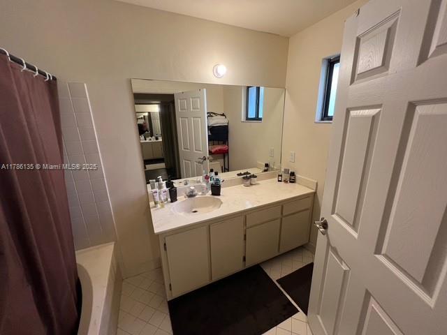 full bath featuring tile patterned flooring and vanity