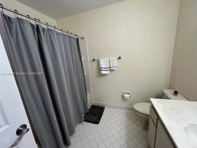 bathroom with tile patterned flooring, baseboards, toilet, and vanity
