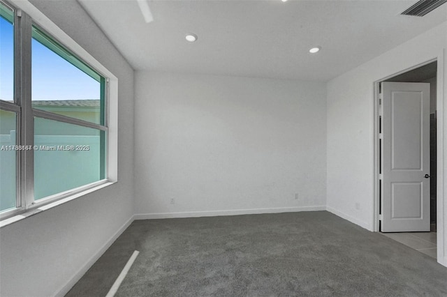 unfurnished room with carpet floors, baseboards, recessed lighting, and visible vents